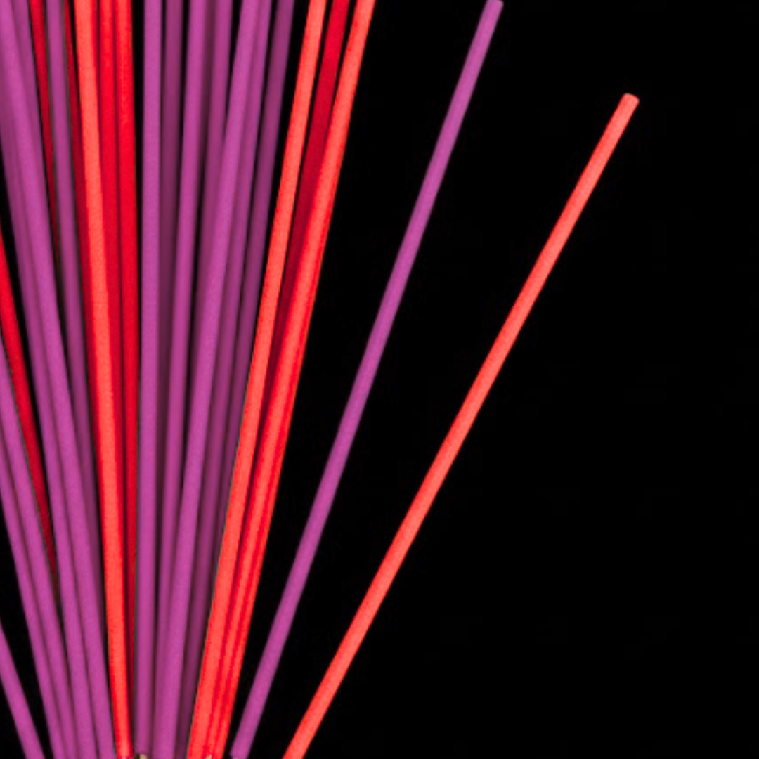 Red and purple INCENSE on a black background
